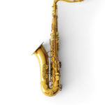 Saxophone on color background